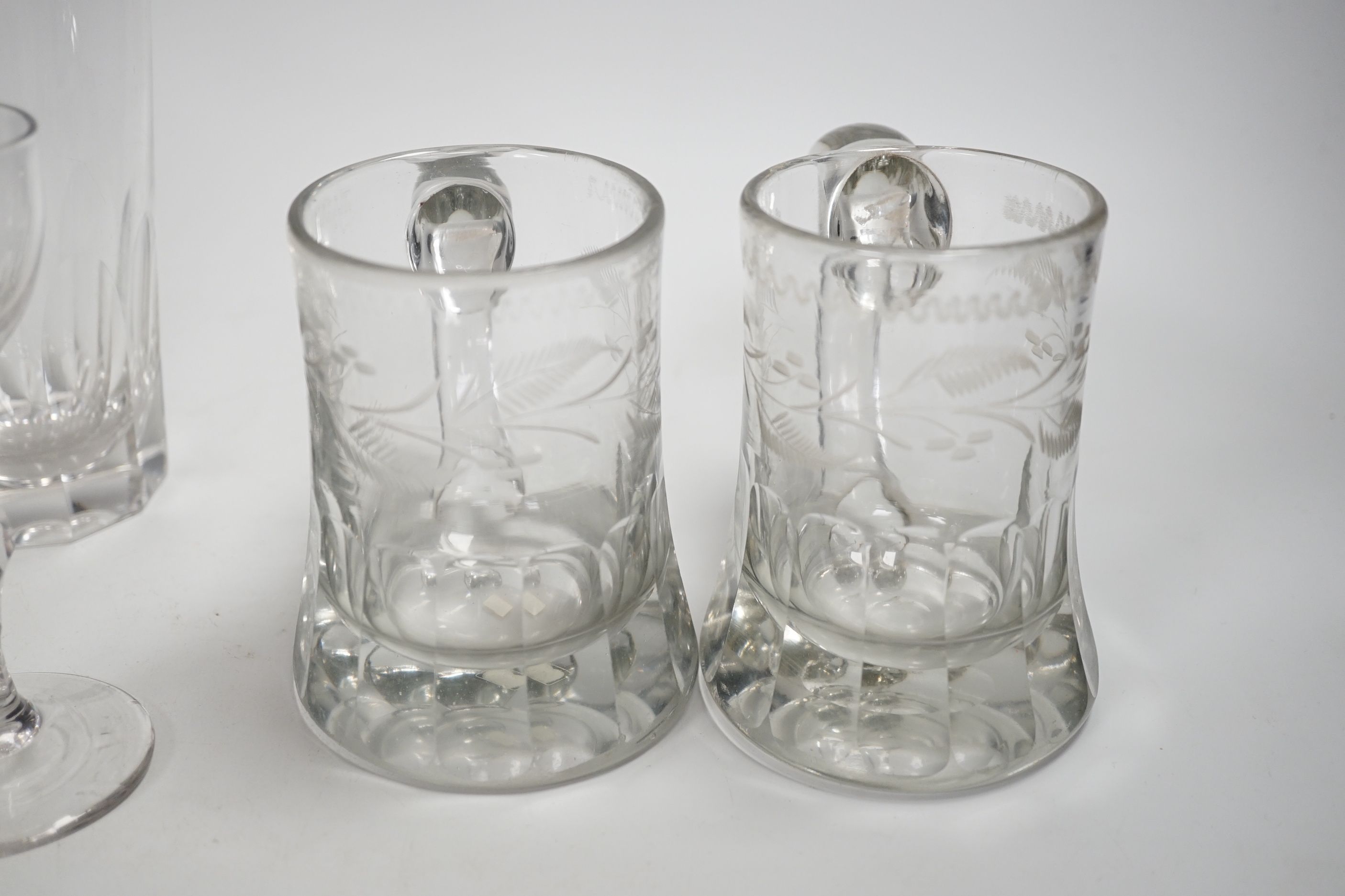 A pair of Victorian pub tankards, engraved with floral motifs and one acid etched with HALF PINT VR and Crown and the number 265, together with two 19th century faceted stem wine glasses, a trumpet glass and two large 19